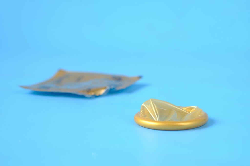 condom and wrapper on a blue background